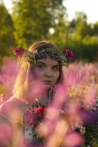 Portrait of woman with pink flower