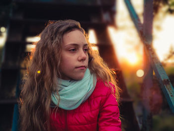 Portrait of young woman looking away outdoors