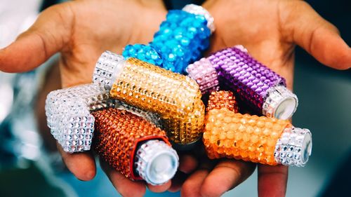 Cropped hands holding colorful decorations