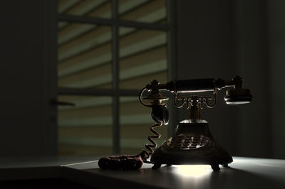 Close-up of electric lamp on table