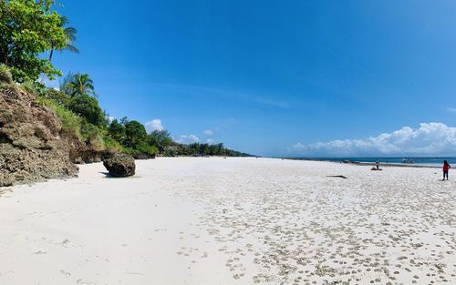 Scenic view of beach against clear blue sky