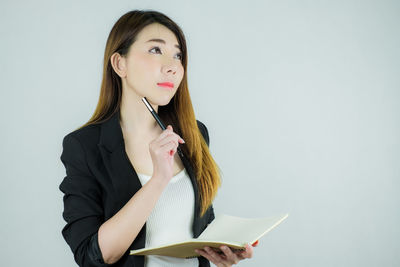 Portrait of a beautiful young woman over white background