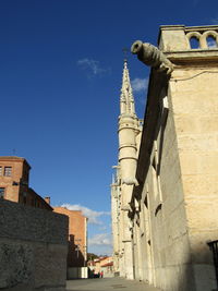 Low angle view of tower against blue sky