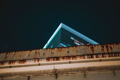 Low angle view of illuminated building against sky at night