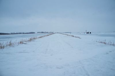 Snow covered field against sky