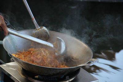 Cropped hand of person preparing food