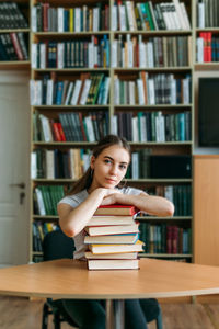 Portrait of woman sitting on table