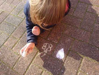 High angle view of child on footpath