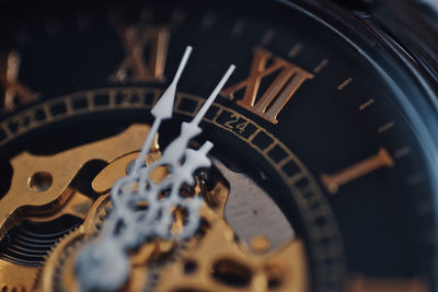 Close-up of clock on metal grate