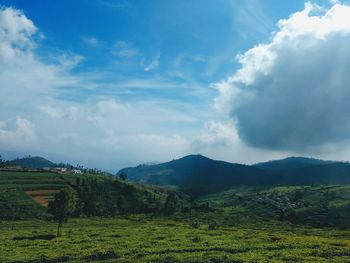 Scenic view of green landscape against sky