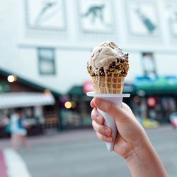 Close-up of hand holding ice cream cone