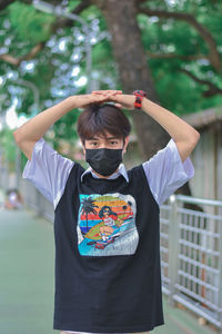 Full length of boy standing against wall