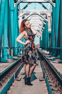 Full length portrait of woman at railroad station