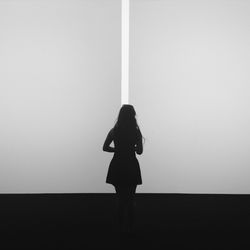 Full length of woman standing on railing