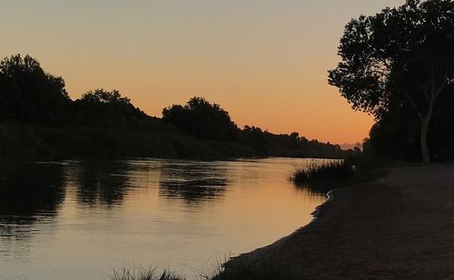 Scenic view of lake against sky during sunset