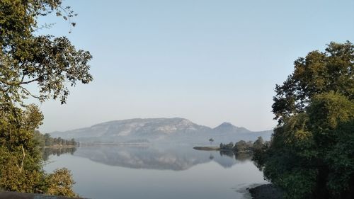 Scenic view of lake and mountains against clear sky