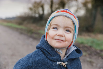 Close-up portrait of cute girl standing outdoors during winter