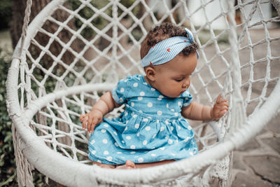 Cute baby girl sitting outdoors