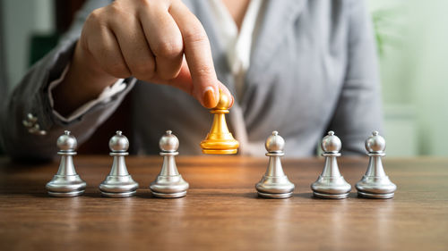 Midsection of man playing chess