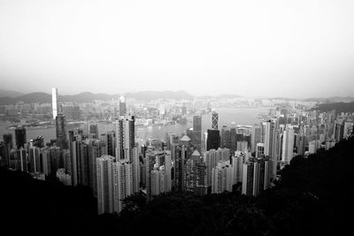 Aerial view of buildings in city against sky