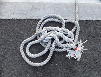 Close-up of rope tied on ground