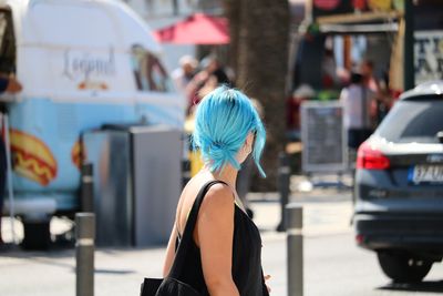 Rear view of woman walking on street in city