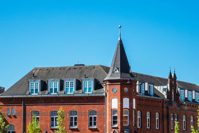 Low angle view of old building against blue sky