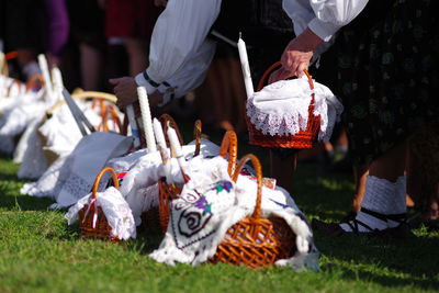 Low section of woman wearing traditional shoes while sitting on grass