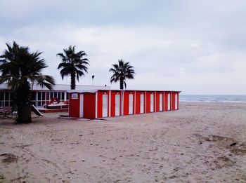 Lifeguard hut on beach against sky