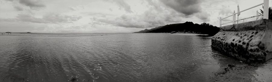 Scenic view of sea against cloudy sky