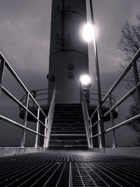 Low angle view of illuminated staircase against sky