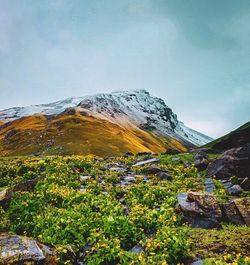 Scenic view of land and mountains against sky