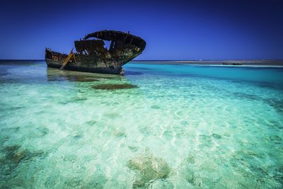 Scenic view of sea against clear blue sky