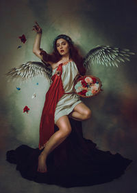 Full length of young woman looking away