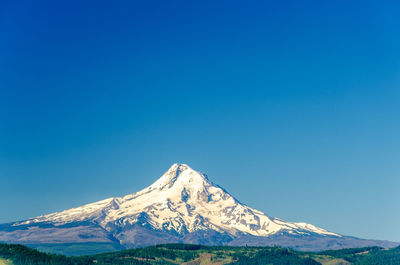 Scenic view of mount hood against clear blue sky during winter