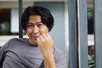 Portrait of man smiling while sitting in room