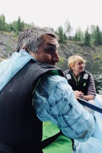 Rear view of father with daughter against sky