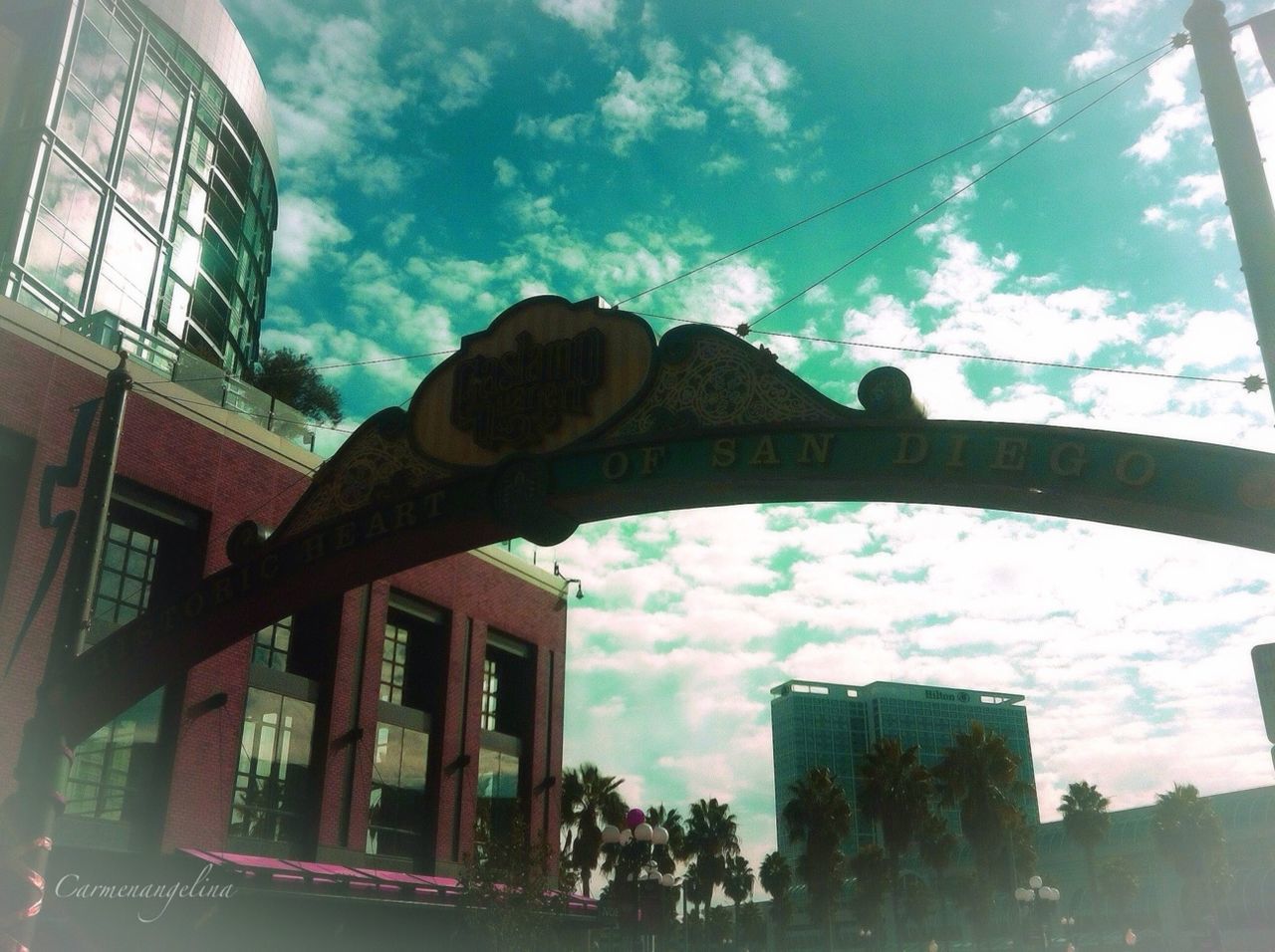 architecture, built structure, building exterior, sky, low angle view, cloud - sky, cloud, reflection, city, building, glass - material, cloudy, day, outdoors, window, no people, sunlight, modern, tree, arch