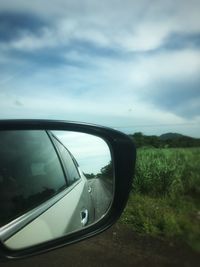 Reflection of sky on side-view mirror