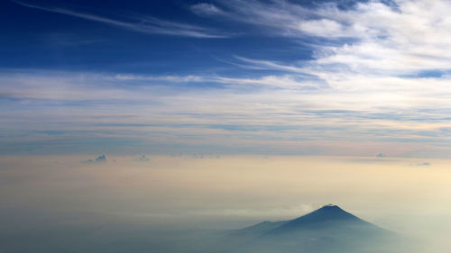 The ring of clouds adorns the top of the mountain