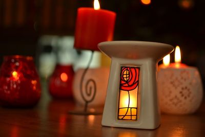 Close-up of lit tea light candles on table