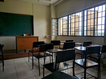 Empty chairs and tables in classroom