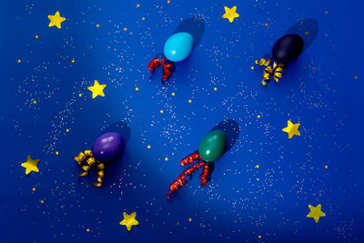 Digital composite image of balloons against blue background