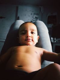 Portrait of shirtless boy sitting