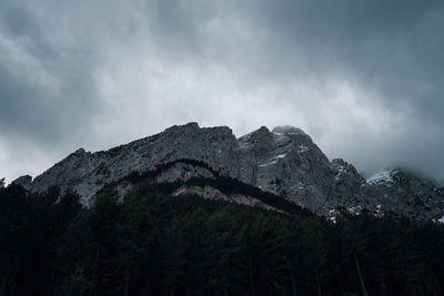 Low angle view of snowcapped mountains against sky