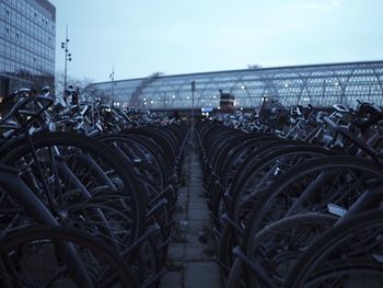 Bicycles parked in city against sky