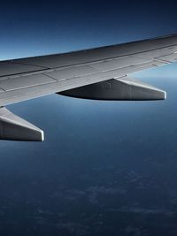 Airplane wing against blue sky