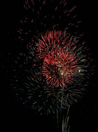 Low angle view of firework display at night