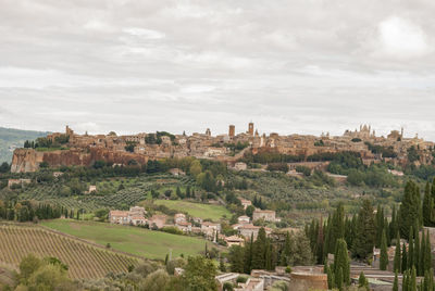 Panoramic view of trees and buildings against sky