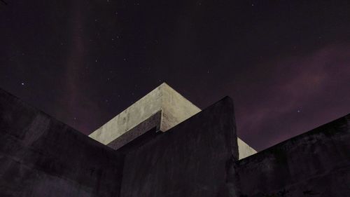 Low angle view of building against sky at night